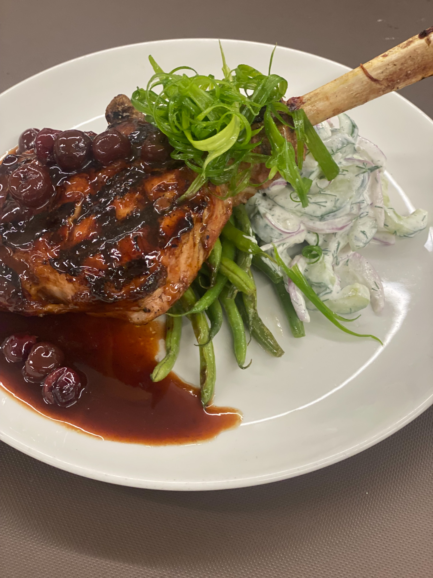 Grilled-pork-chop-cherry-sauce-salad-greens-Vesper-Country-Club
