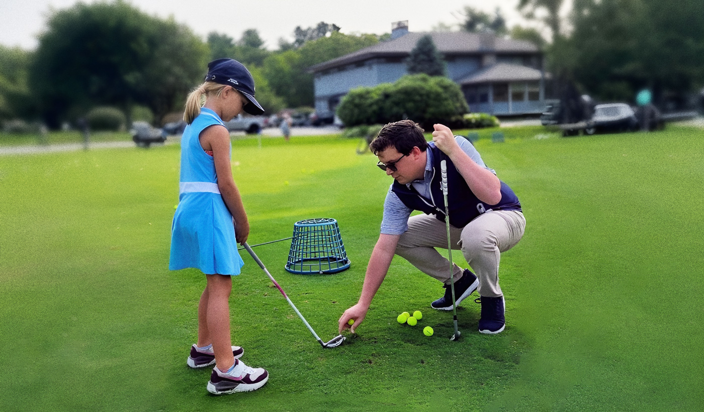 Golf-coach-instructing-young-girl-Vesper_Country_Club